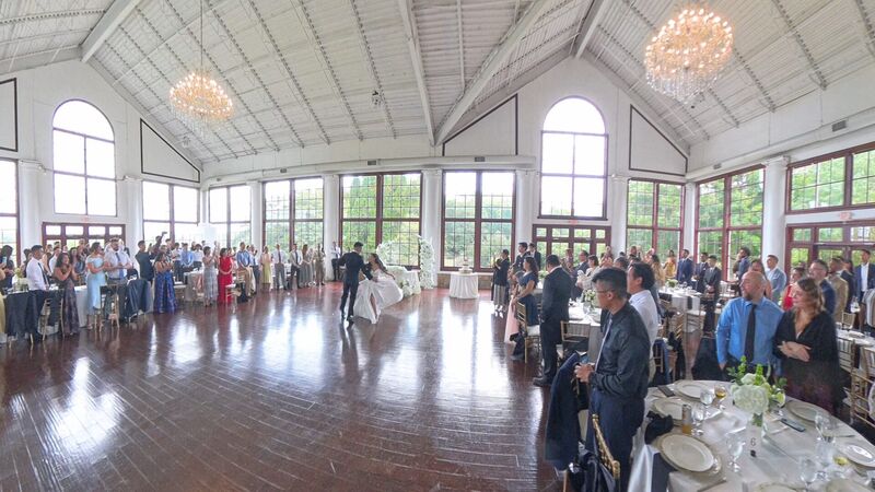 First dance in a bright reception room with daylight still visible outside