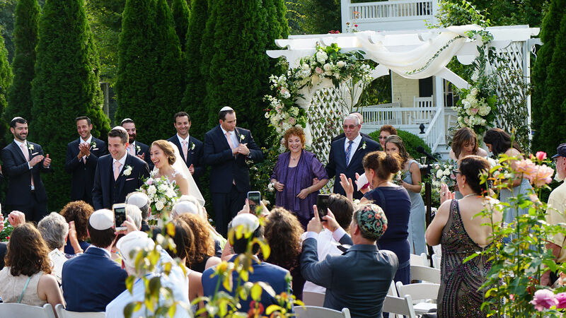 Outdoor wedding ceremony with discreet microphone and speaker setup