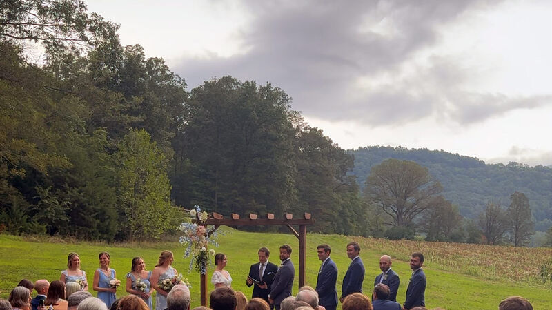 Outdoor wedding ceremony with a dramatic sky, showing why a rain plan matters