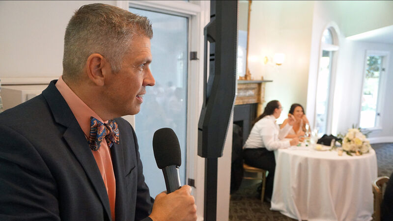 Professional MC with microphone at wedding reception