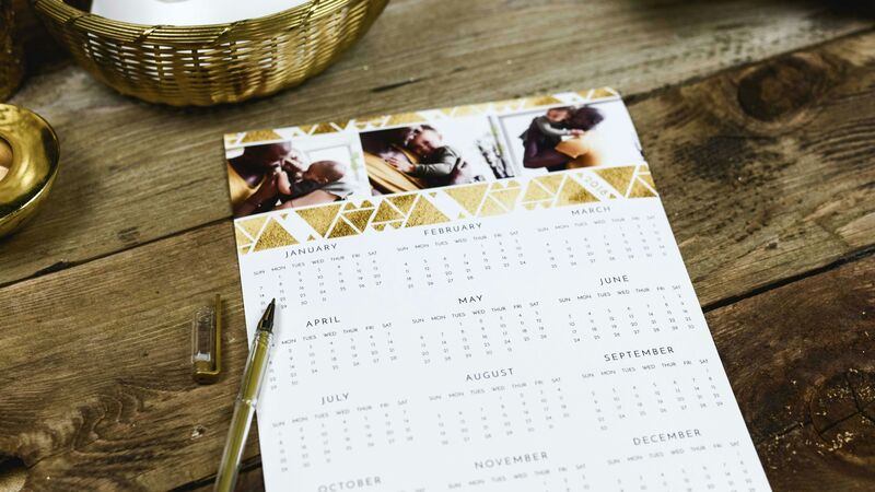 Wedding planning calendar with dates circled and a pen resting on it
