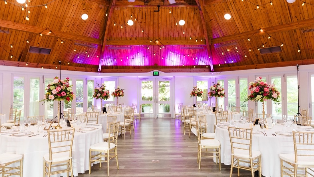 Airlie Hotel pavilion reception with uplighting, string lights, and elegant table settings
