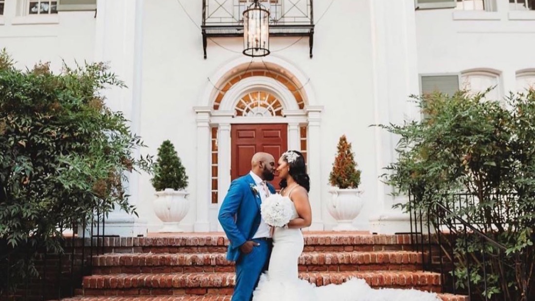 Wedding couple at the grand entrance of Grey Rock Mansion in Pikesville