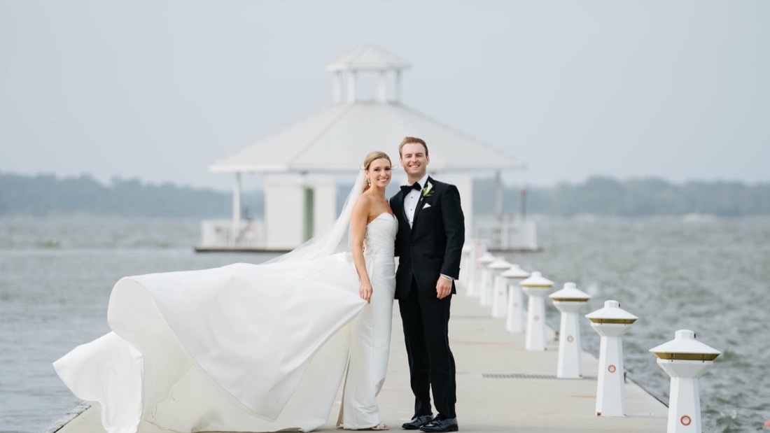 Wedding couple on the marina pier at Hyatt Regency Chesapeake Bay with the Choptank River